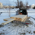Loading lumber in the snow.